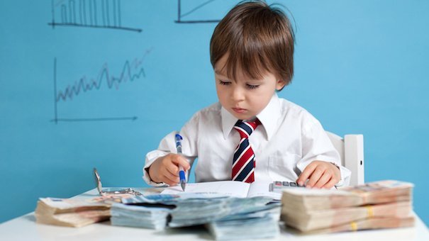 Young boy, counting money and taking notes